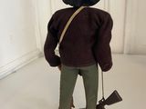 a figurine of a man wearing a hat and holding a gun