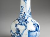 a blue and white vase with birds and flowers on it