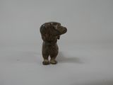 a small figurine of a dog on a white surface