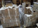 a pile of boxes sitting on pallets in a warehouse