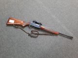 the rifle is laying on the floor next to the gun