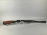 a shotgun with a wooden barrel and a black handle