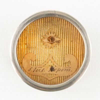 an image of a close up of a button on a white surface