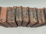 several old books stacked on top of each other on a table