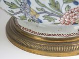 underside view of a decorative bowl with flowers on a gold stand