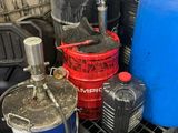 many barrels and buckets of water sitting on the floor