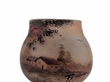 a vase with a painting on it on a white surface
