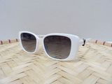 white sunglasses on a woven table with a pink and white stripe