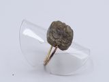 a ring with a stone embedded in it on a clear glass