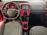 the interior of a small car with red trims and a steering wheel