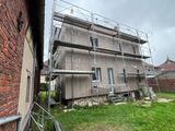a scaffolding on the side of a building with scaffolding around it