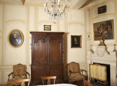 an image of a bedroom with a bed and a cabinet