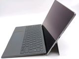 a laptop with a keyboard on it sitting on a white surface