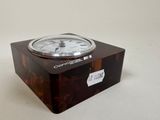 a clock that is sitting on top of a wooden box
