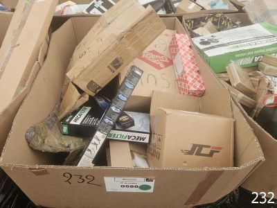a cardboard box full of assorted items in a pile