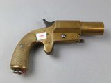 a close up of a gun on a table with a tag on it