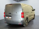 a silver van that is parked in a room
