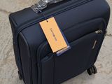 a piece of luggage sitting on the ground with a tag attached to it