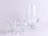 a pitcher and two glasses sitting next to each other on a table