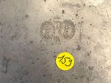 a yellow sticker on the bottom of a large metal bowl