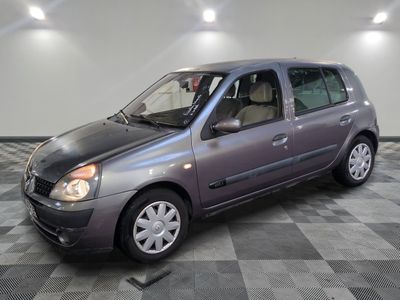 a picture of a small grey car parked in a garage