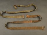 two belts and a belt on a table with a piece of cloth
