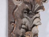 an antique carved wood corble with flowers and leaves on it
