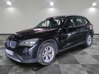 a picture of a black bmw suv parked on a checkered floor