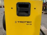 a yellow box sitting on top of a pallet in a warehouse