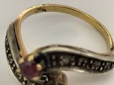 an image of a gold and silver ring with a ruby stone