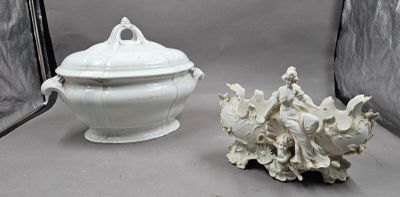 a white bowl with a lid sitting next to a sea shell