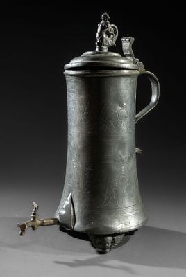 an antique silverplated coffee pot with a bird on top
