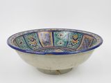 an image of a blue and green bowl on a white surface
