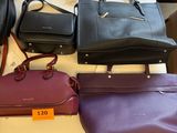 a lot of purses on a table in a store