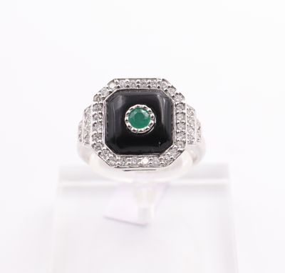 a close up of a ring with a black stone surrounded by white diamonds