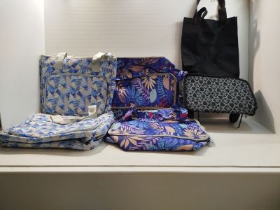 many bags on a shelf next to each other