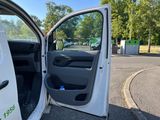 a white van with its door open on the street