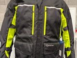 a black and yellow jacket on display on a mannequin