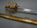 a gold colored sword and a gold colored sword on a gray surface