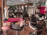 many chairs in a room with mirrors on the walls
