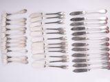 a lot of forks and spoons sitting on a table