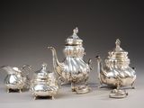 silver plated tea and coffee set on stand on grey background