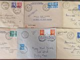 several old envelopes with stamps on them sitting on a table