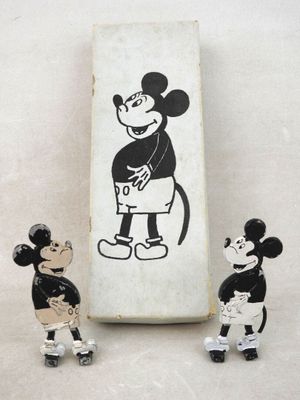 three figurines of mickey mouse and mickey mouse