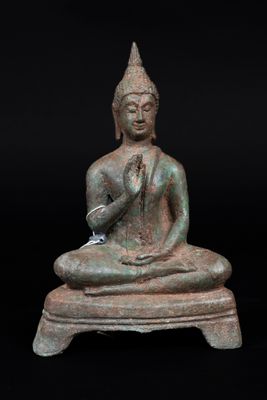 an image of a statue of a person sitting on top of a table