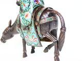 a figurine of a man riding a horse on a white background