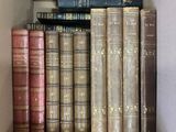 a box full of old books sitting on a shelf