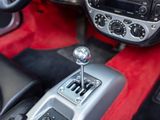 a close up of a car ' s interior with a red carpet