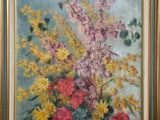 tableau représentant un vase de fleurs dans un cadre doré sur fond bleu