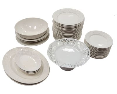 a lot of white plates and bowls on the table